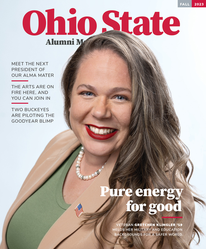 The cover of the Fall 2023 issue of Ohio State Alumni Magazine shows a smiling woman with long hair and bright lipstick wearing a business suit. She's leaning slightly toward the camera, as if getting ready to have a conversation with the reader or warmly greet them. The main headline says “Pure energy for good” in describing Gretchen Klingler.