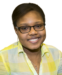 A black woman wearing glasses smiles, showing her dimples, in this headshot photo.