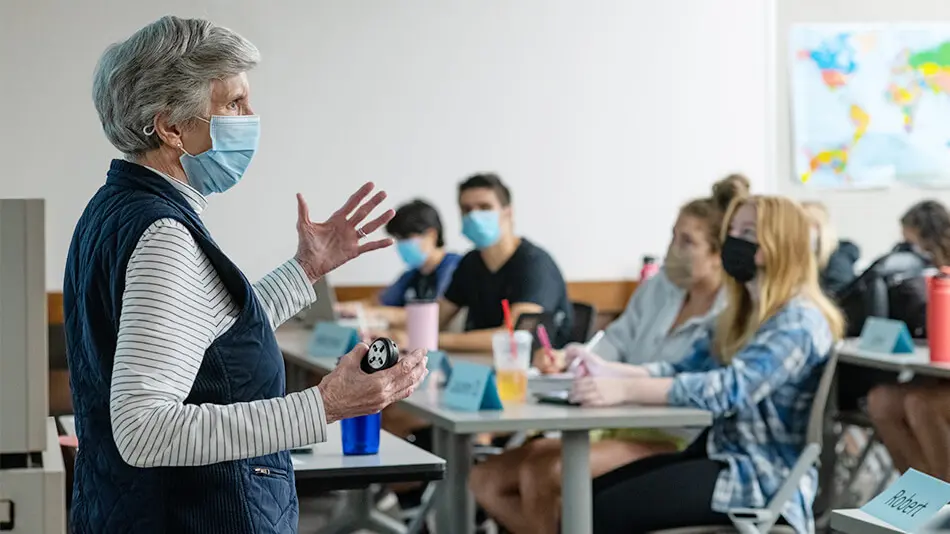 female professor teaches a college class