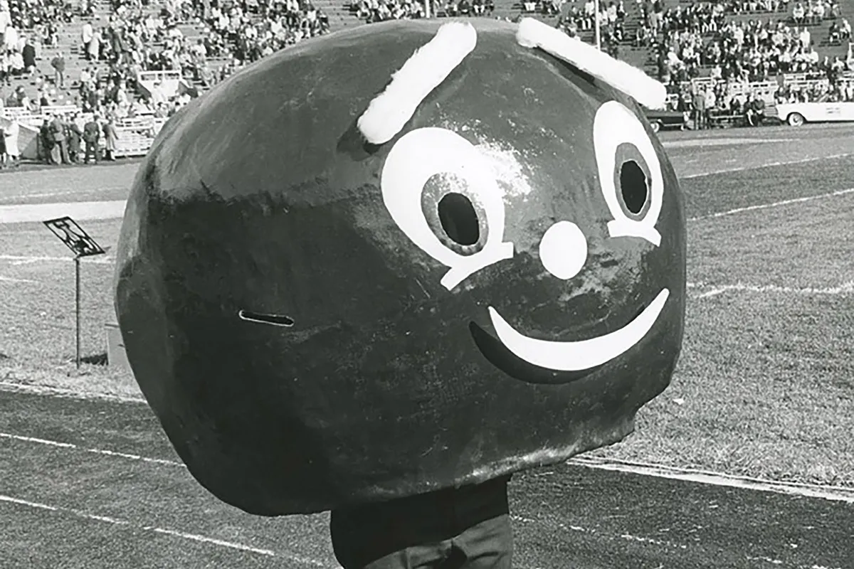 In his original form, Brutus Buckeye was a giant papier mache head that covered the student wearing it from head to hips. This is an old black and white photo of Brutus in Ohio Stadium.