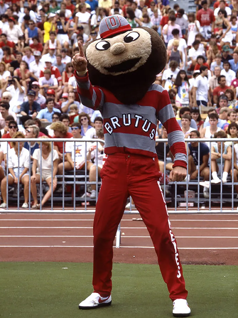 This Brutus is a big fuzzy head vaguely heart-shaped and cross-eyed. He points across a crowded Ohio Stadium