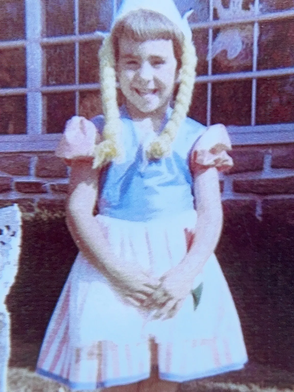 Young Molly is costumed as a little dutch girl with long yarn braids.