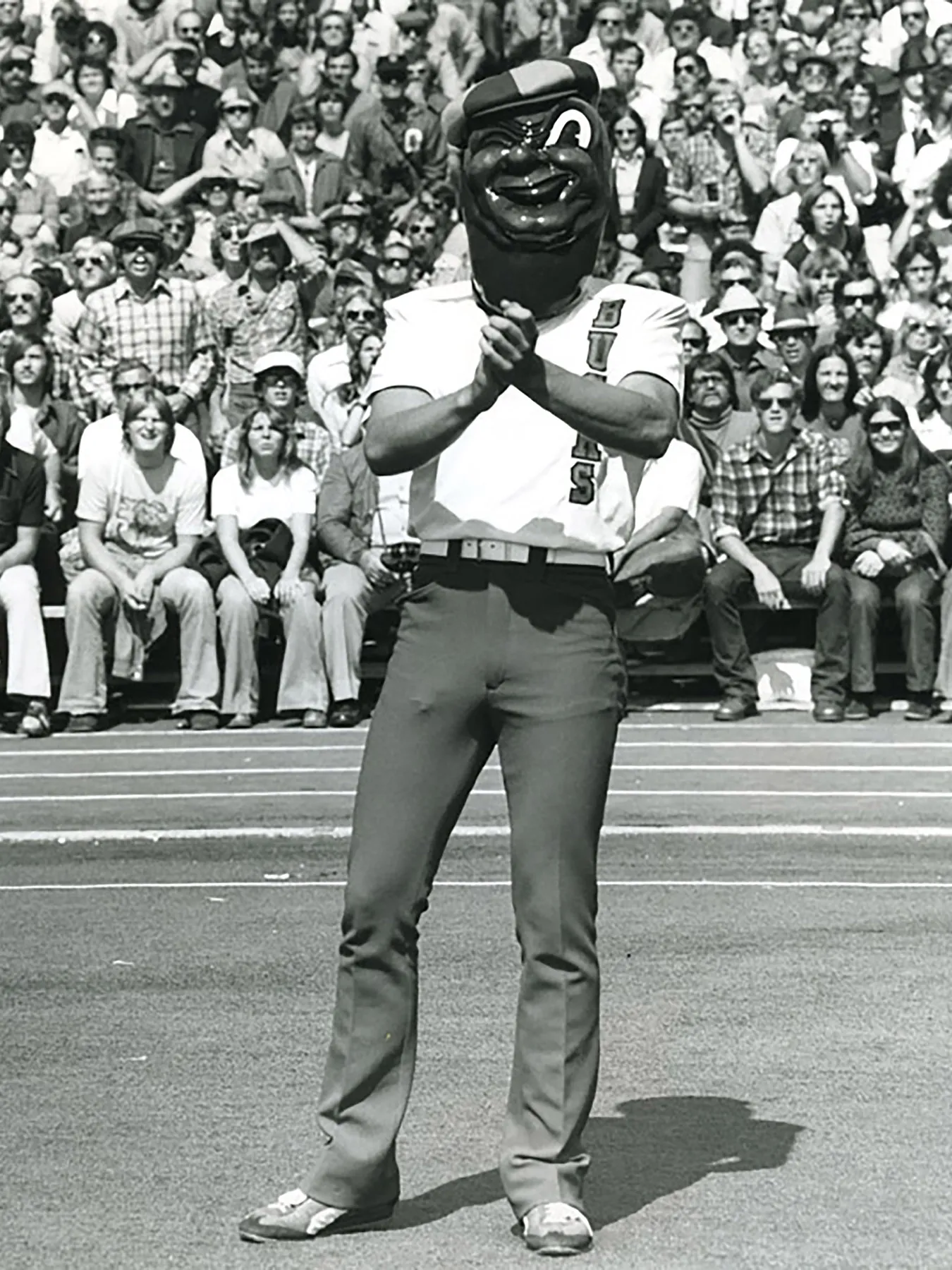 Perhaps Brutus' creepiest era is shown in this photo. He 's wearing golf-style clothes and has a little shaped head that is reminiscent of the old Mr. Peanut from Planters' peanuts. One eye is permanently closed in a wink.