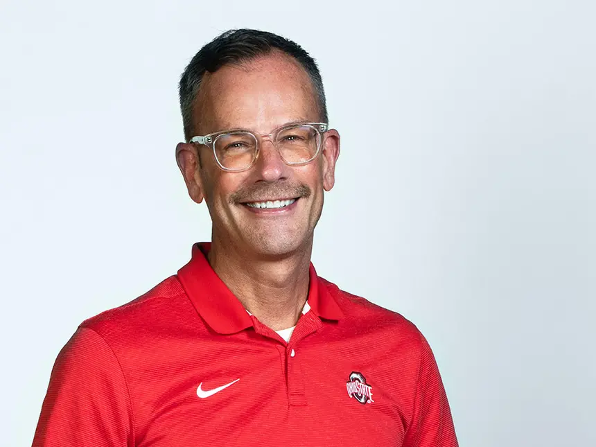 matt hall wearing a red ohio state polo smiling at camera