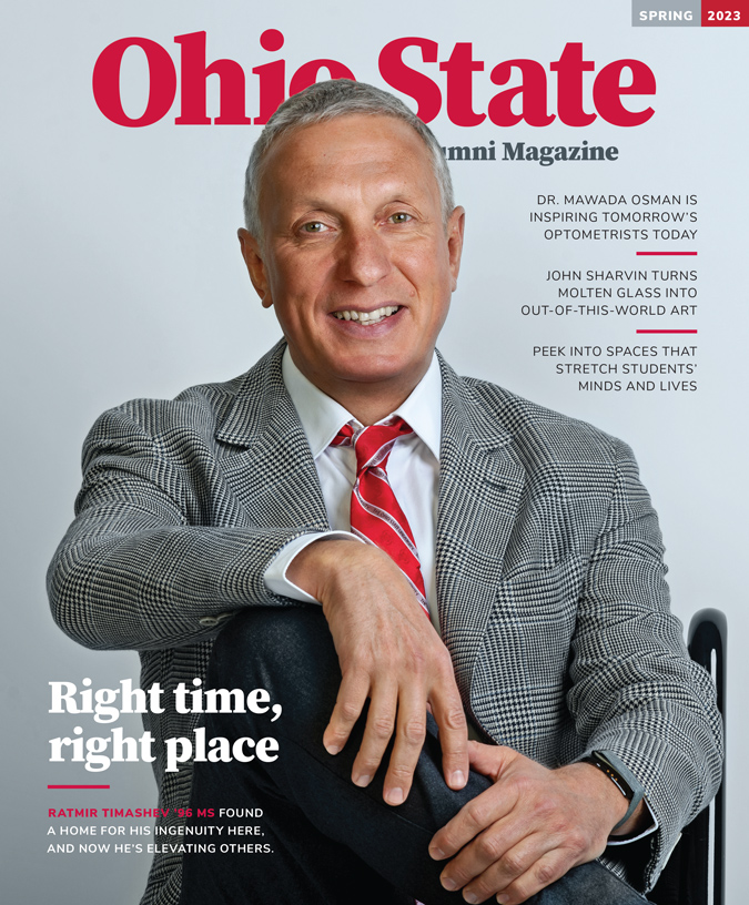 The cover of Ohio State Alumni Magazine's Spring 2023 issue shows an older white man wearing a gray suit coat and scarlet tie. He is Ratmir Timashev, and his smile is so genuine, it crinkles the skin around his eyes.