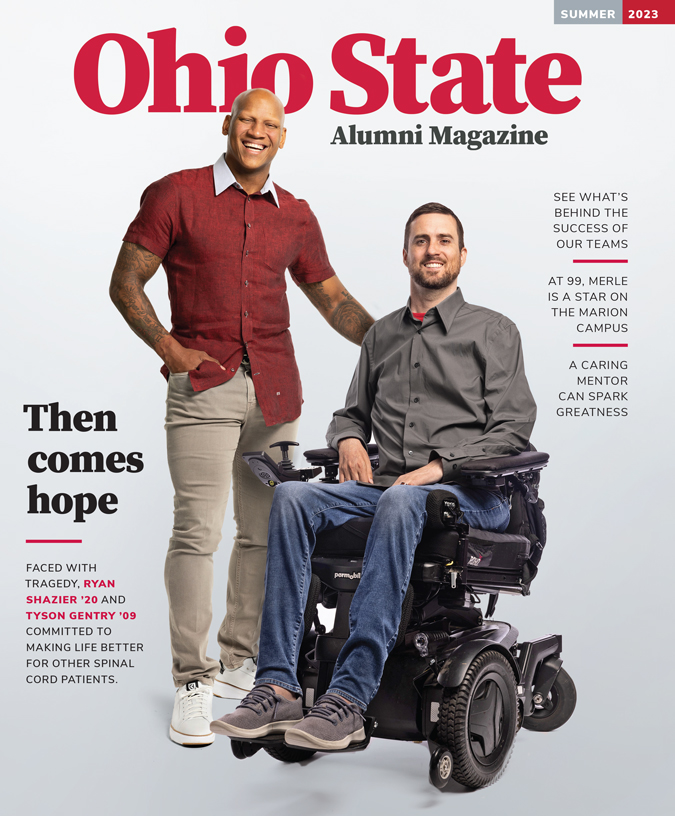 The cover of Ohio State Alumni Magazine's Summer 2023 issue shows two smiling men: A Black man stands with a hand tucked in a pocket and the other on the wheelchair of the second man, a white man with beard. They both look happy and friendly.