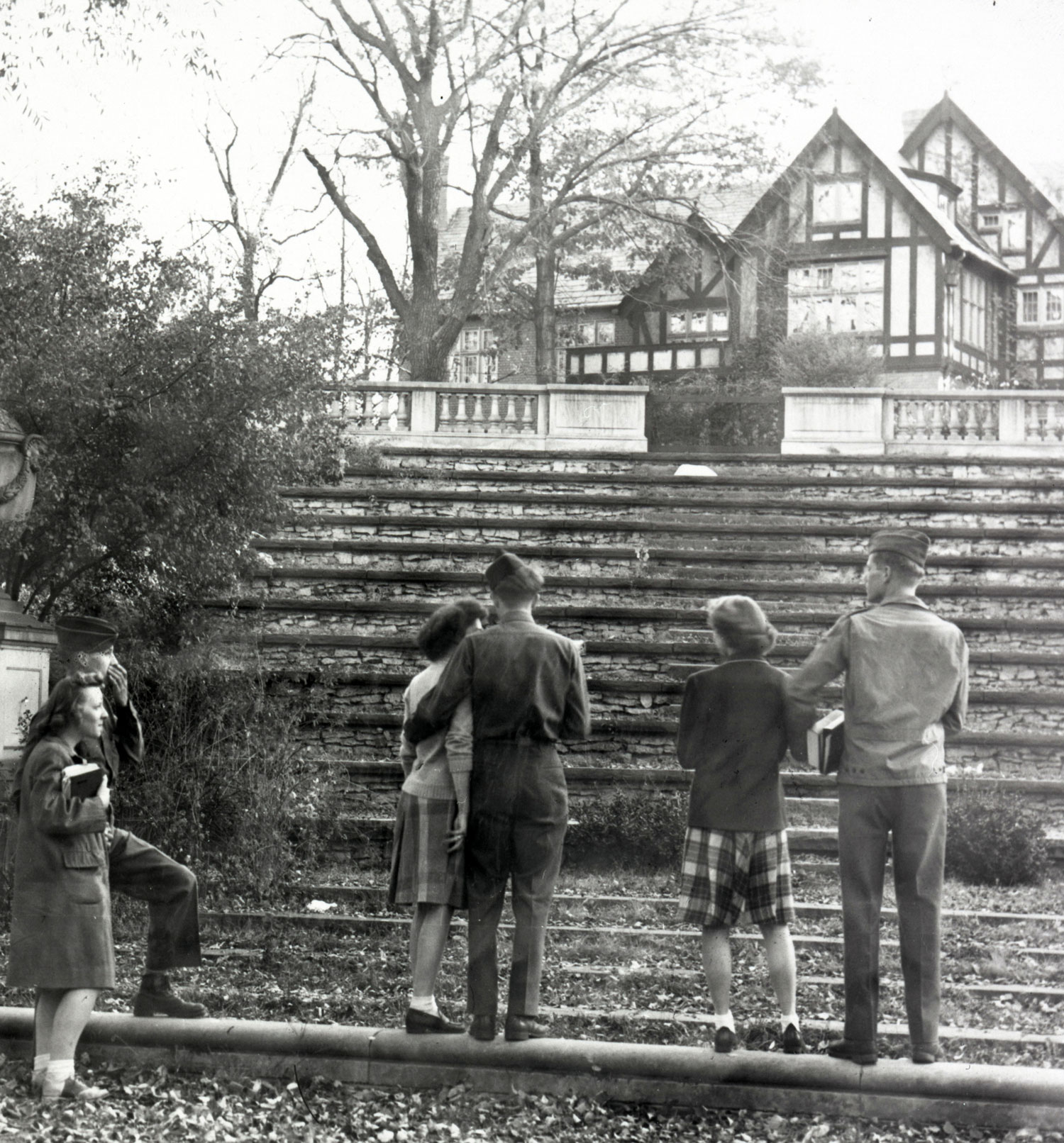 In this 1945 photos, Kuhn House stands in the background as students face away from the camera at the bottom of the campus amphitheater’s stone steps. The people stand in couples—each of the men wears a military uniform.
