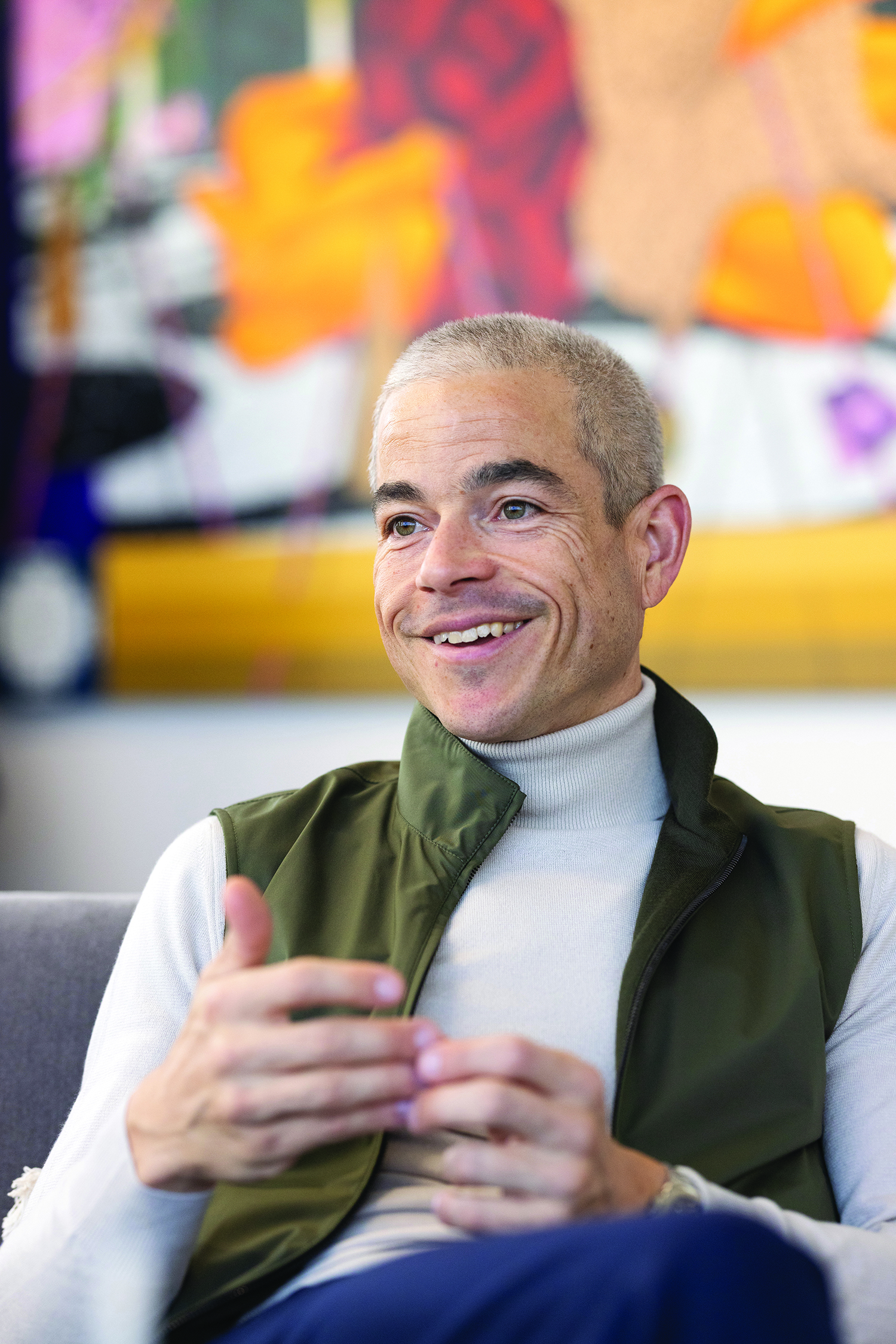 Scantland smiles as he talks while sitting in his office.