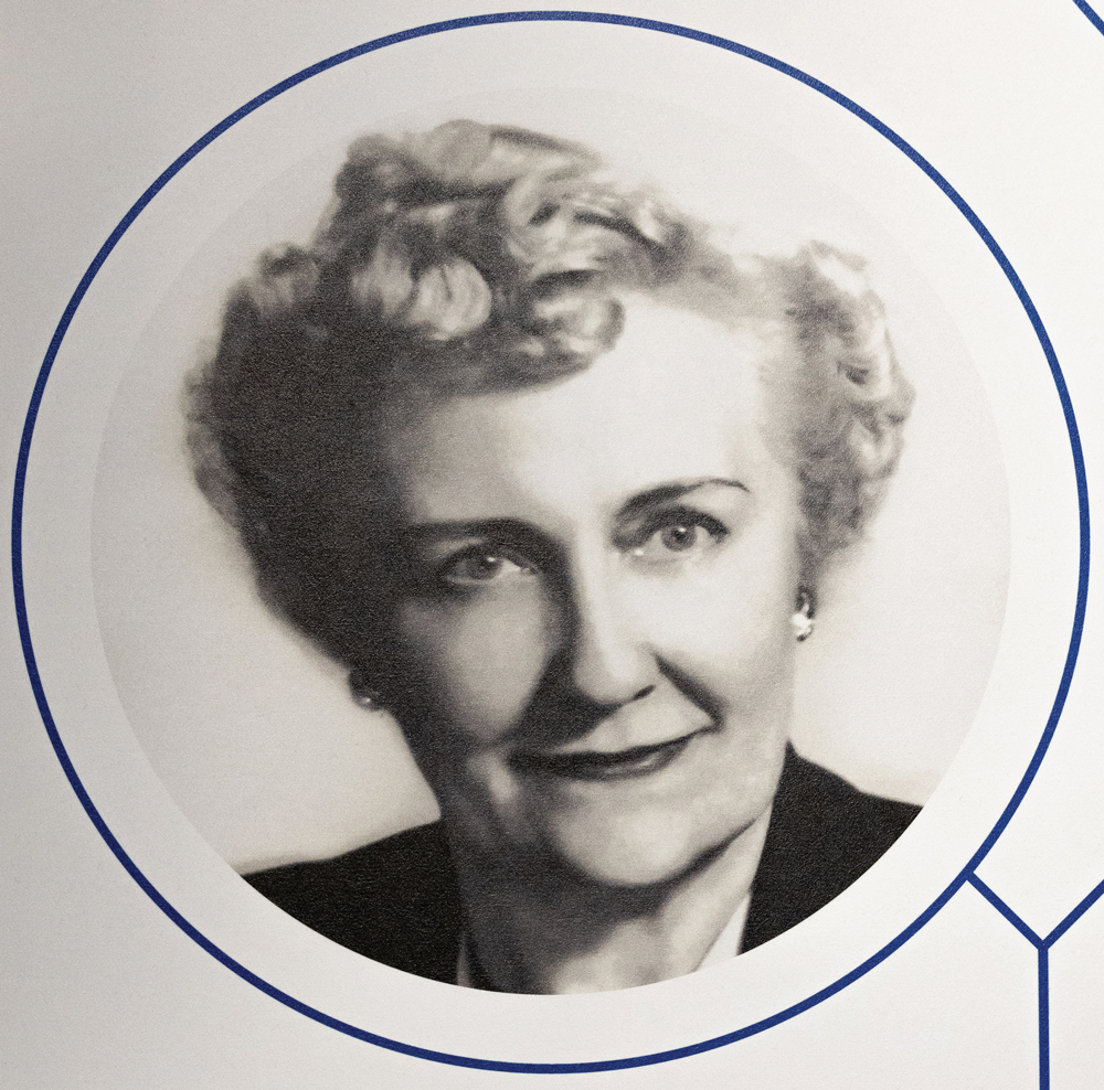 A 1930s woman with pin-curled hair and a soft smile