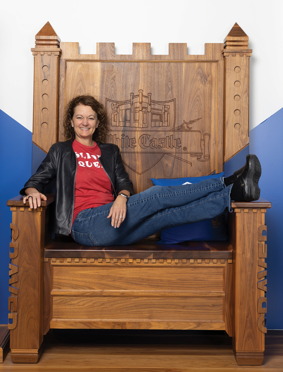 Lisa Ingram laughs as she lounges in the White Castle throne in the company's Craver museum, a favorite destination for customer enthusiasts.