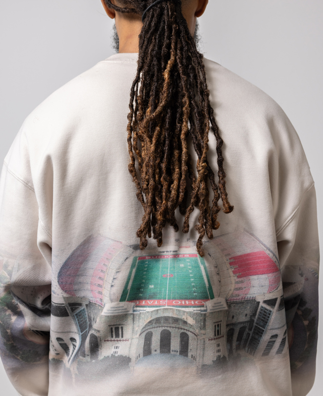 Banner from the back shows how the design is also on the back of his sweatshirt. His dreads hang to mid-back