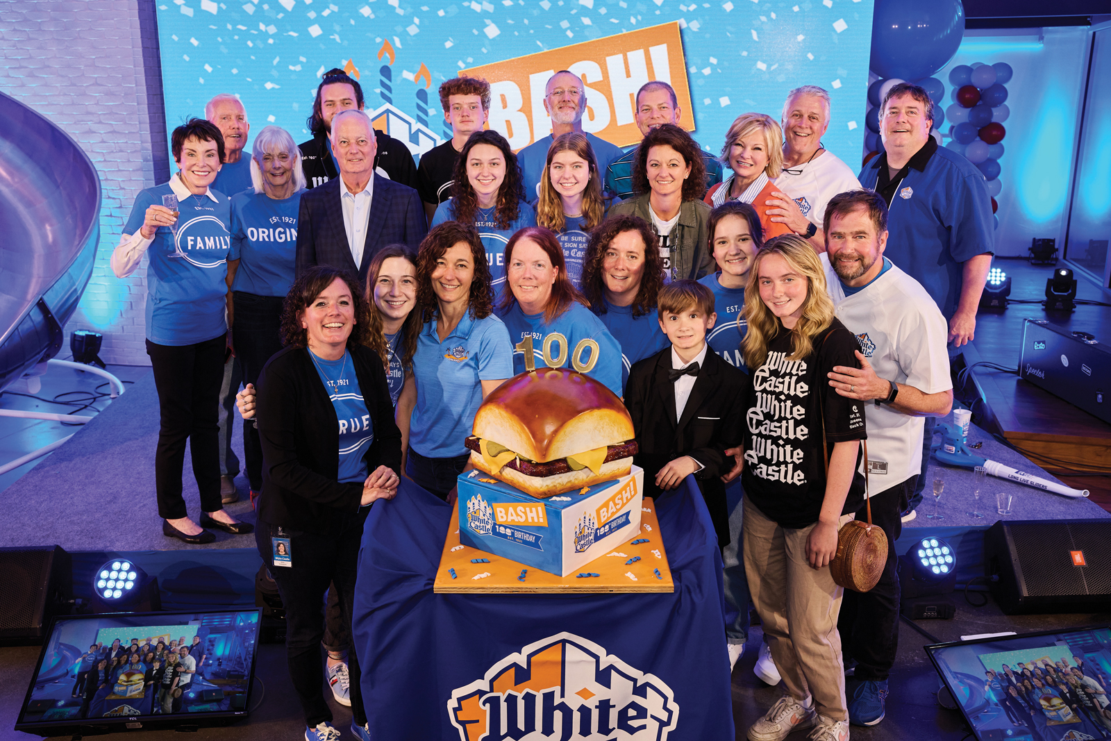 A family photo shows more than 20 people, from kids to grandpa-age. They're all smiling and clustering close for the photo.