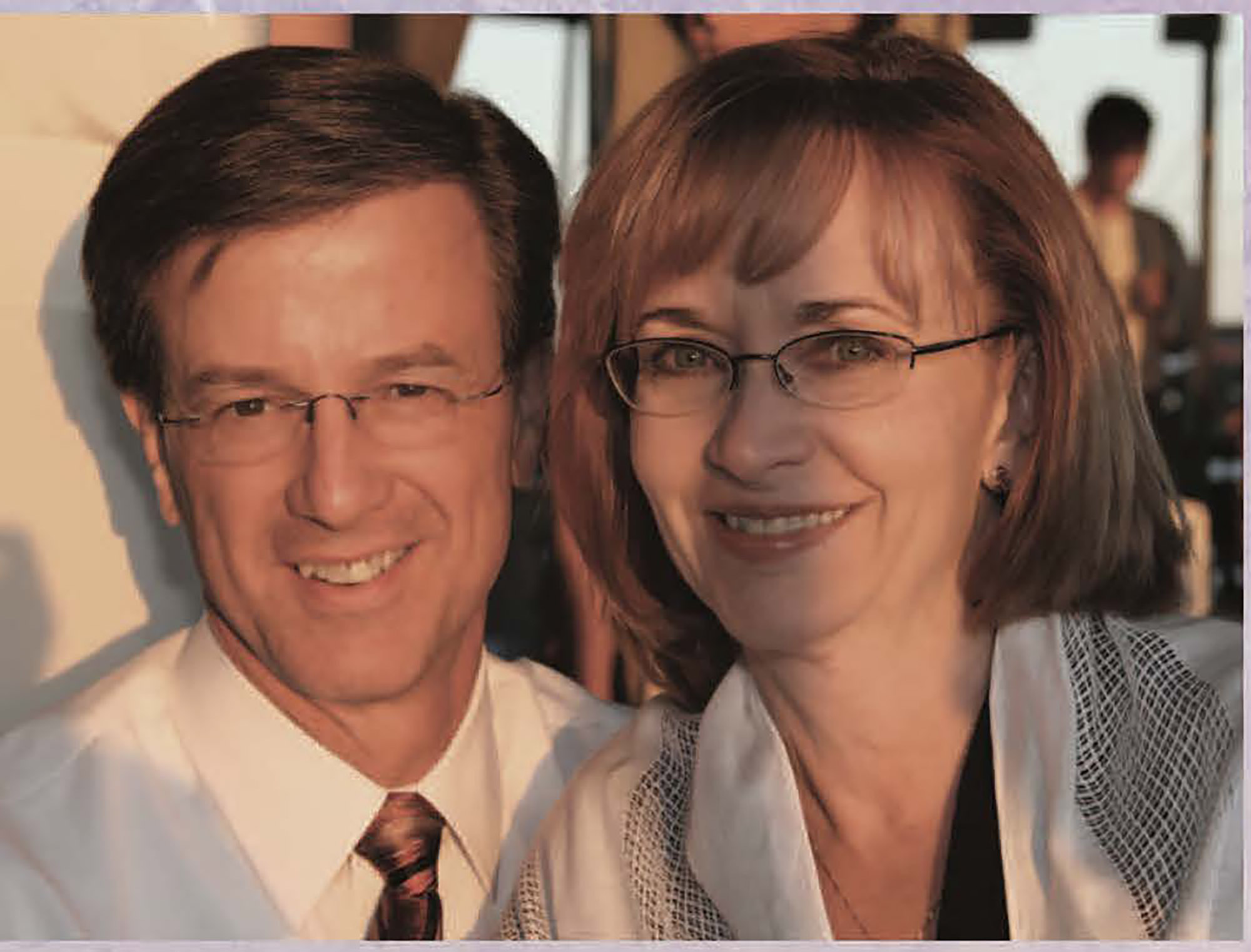 Roy and Judy Smoot smile as they pose for a photo at a dress-up occasion. In that way longtime couples sometimes do, they look similar: They both wear thin-rimmed glasses, smile to the same degree, wear white and have hair of similar shades.