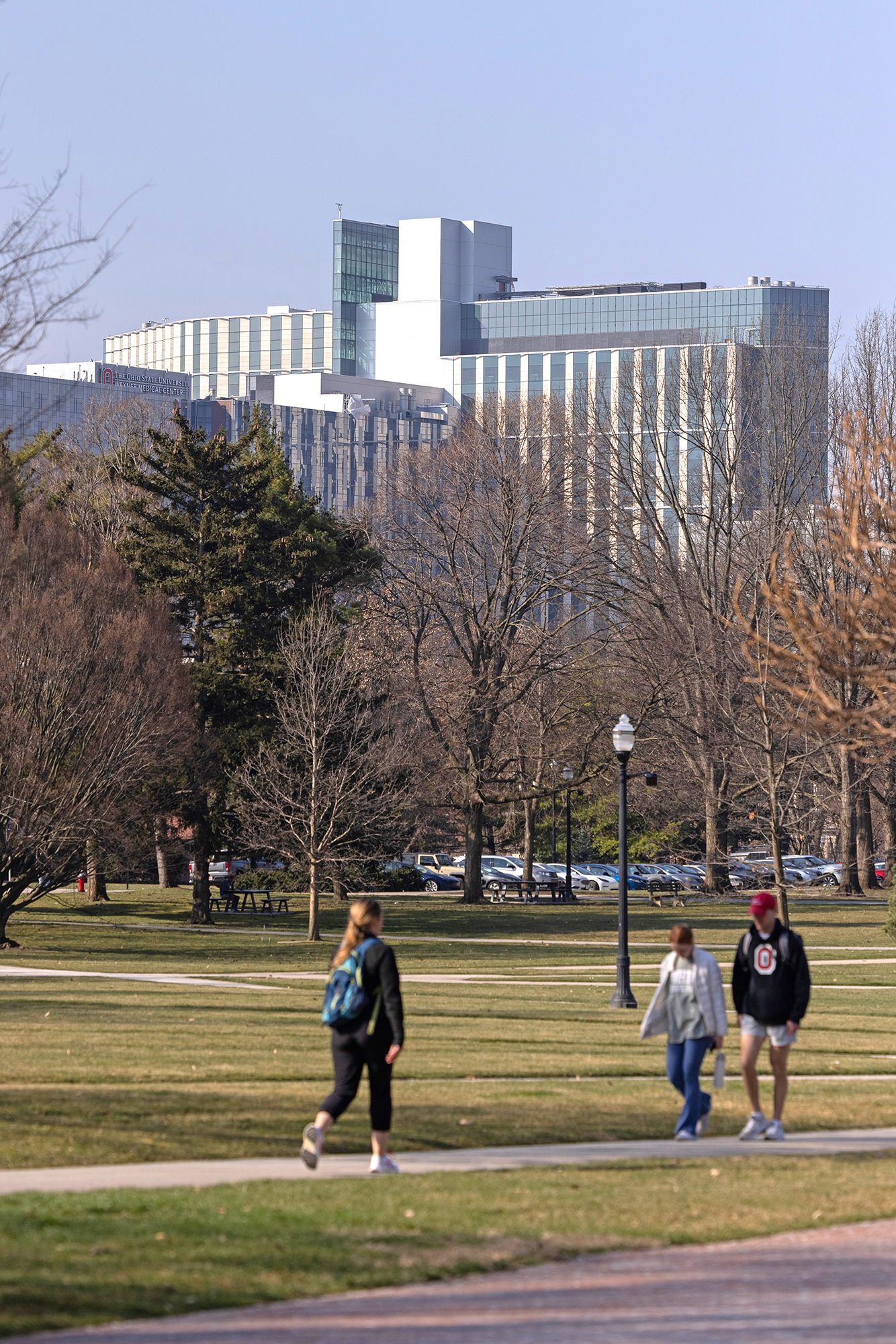 Seen over winter trees that have lost their leaves is the new Wexner Medical Center inpatient tower, which is still udner construction.