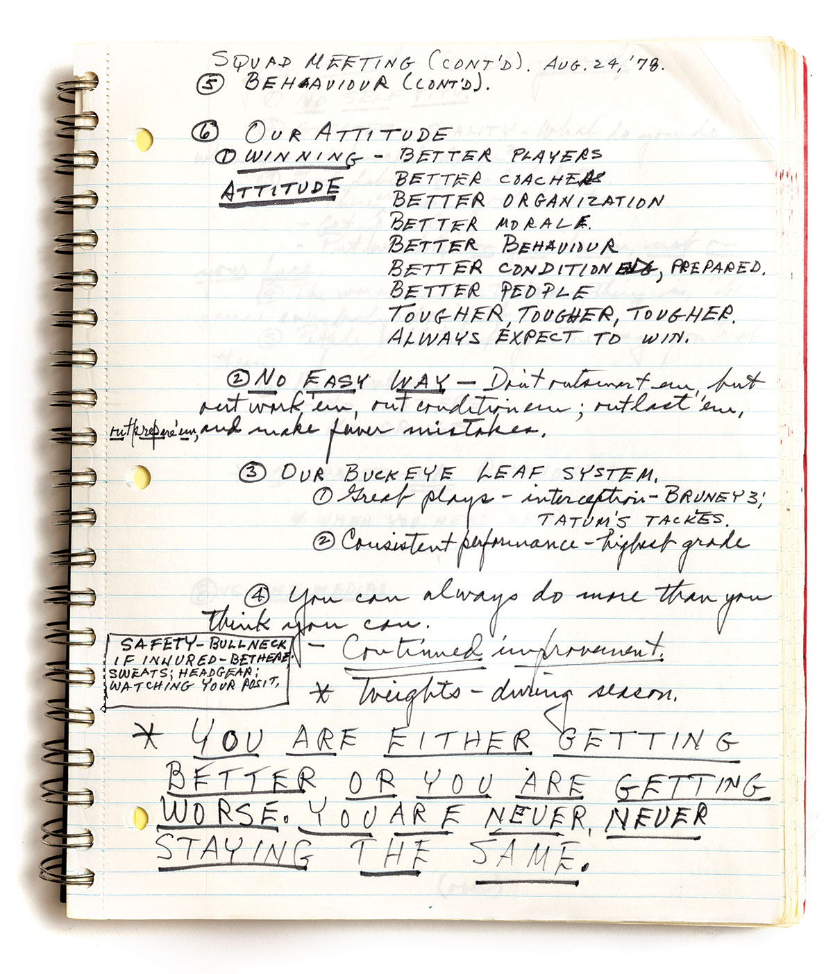 A slightly yellowed notebook is opened to a page with notes made by Woody Hayes, some in all capital block letters and some in cursive. Legible text says: Squad meeting (continued) Aug. 24, 1978. 6. Our attitude—winning attitude. Better players, better coaches, better organization, better morale, better behavior, better conditioning, prepared, better people, tougher, tougher, tougher. Always expect to win. At the bottom of the page, underlined, are the words: You are either getting better or you are getting worse. You are never, never staying the same