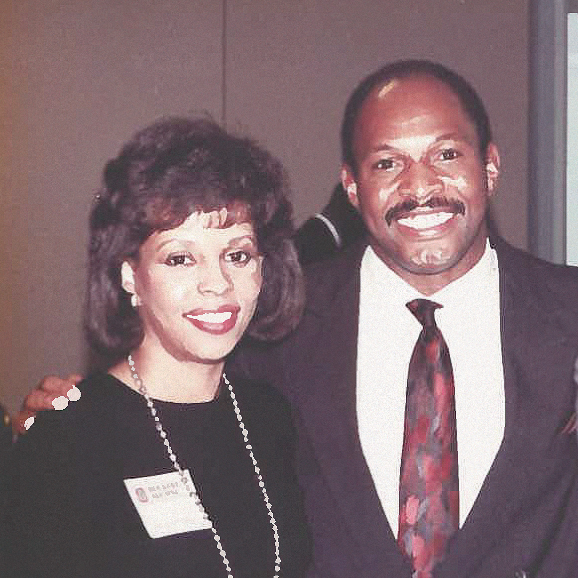 Griffin is all grins as he stands with an arm around his wife, Bonita. She’s a pretty black woman in a black dress and long necklace. He’s wearing a suit and tie and has a neatly trimmed mustache.