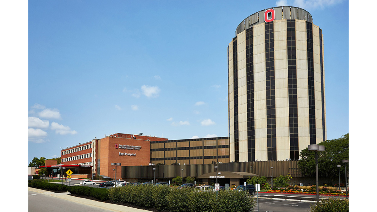 The Ohio State University Wexner Medical Center's East Hospital against a bright blue sky.