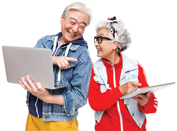 An senior couple outfitted in playful and colorful clothing hold electronic devices as they share a laugh