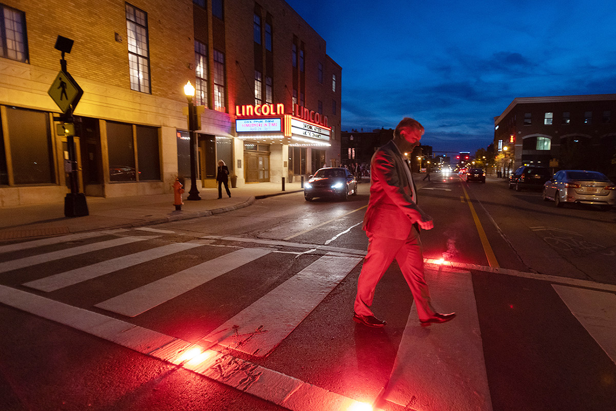 At the end of an active work day Whittington in the crosswalk just outside of the Lincoln Theater headed home for the evening