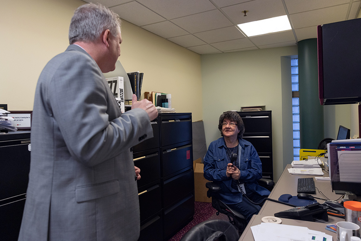 Whittington chats with executive assistant Arline Dimitri in her office