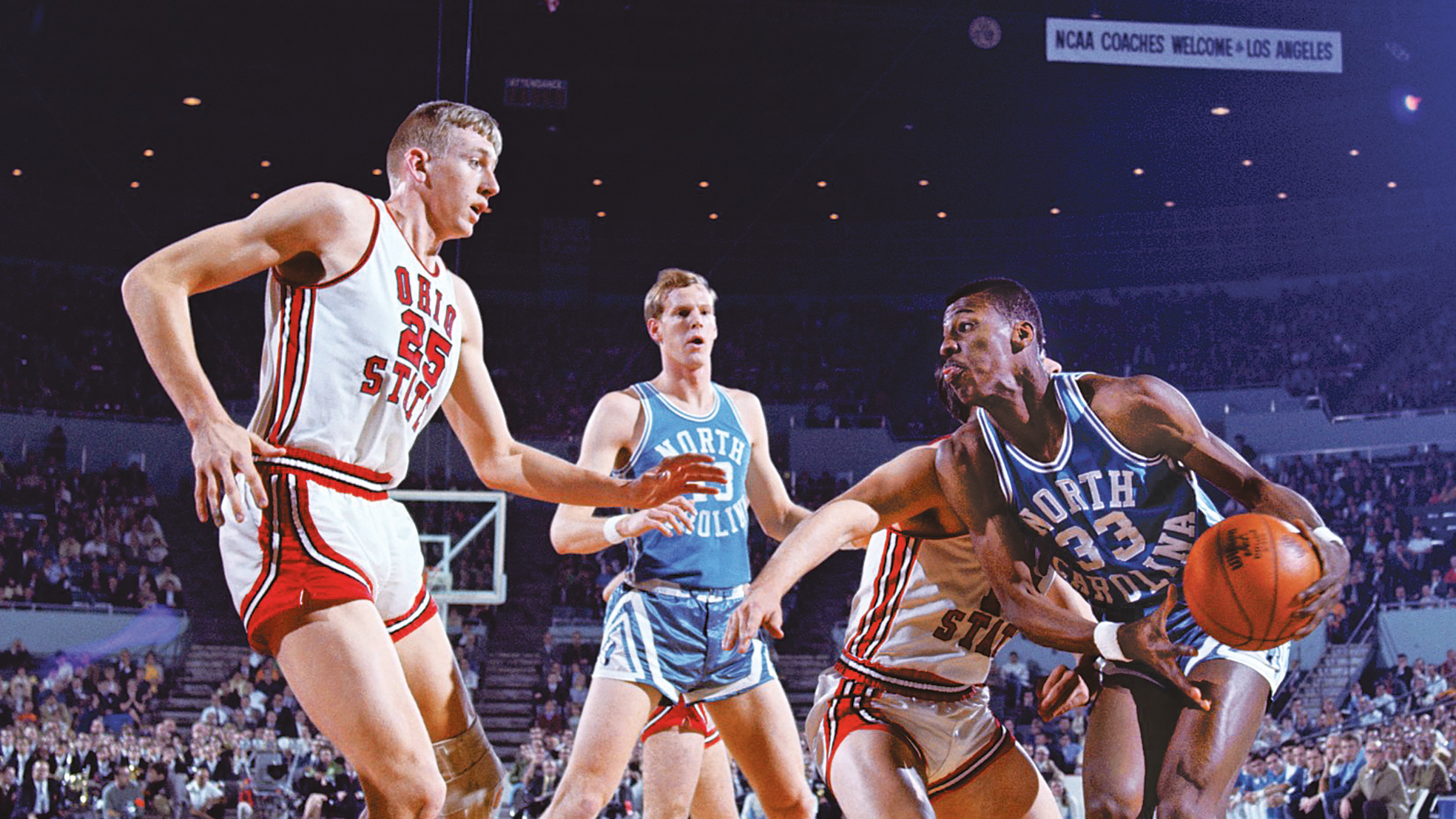 In a scene from a 1968 tournament game, a white, tall, leanly muscled white player from Ohio State keeps his eyes on the ball as it is dribbled by young Black man from North Carolina. Another Ohio State player tries to run interference from behind the North Carolina player, and farther back is another North Carolina player. In the background, the stands are crowded.