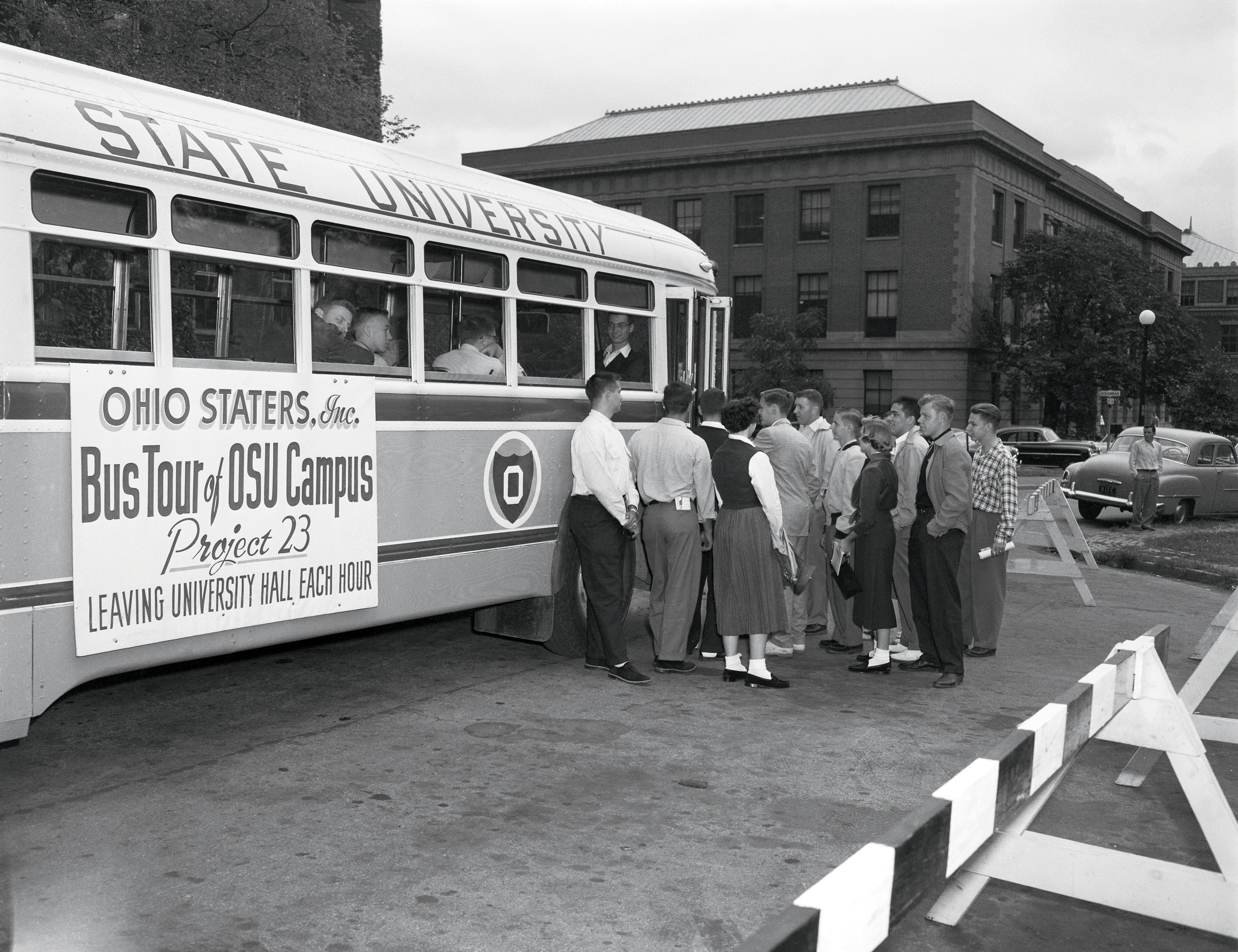 Students boarding old bus on campus