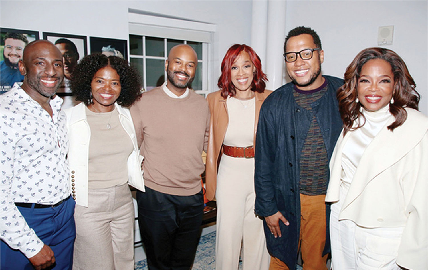 Six people stand with arms around one another. Half are men and half are women; all are black, dressed up and smiling brightly. The most famous is Oprah Winfrey, who stands at right.