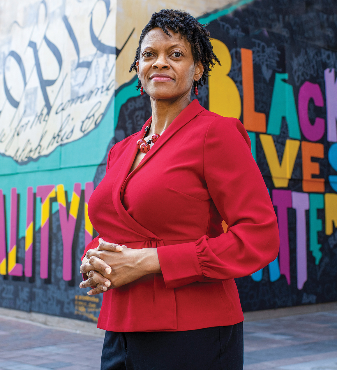 portrait of Andrea N. Williams standing in front of colorful murals