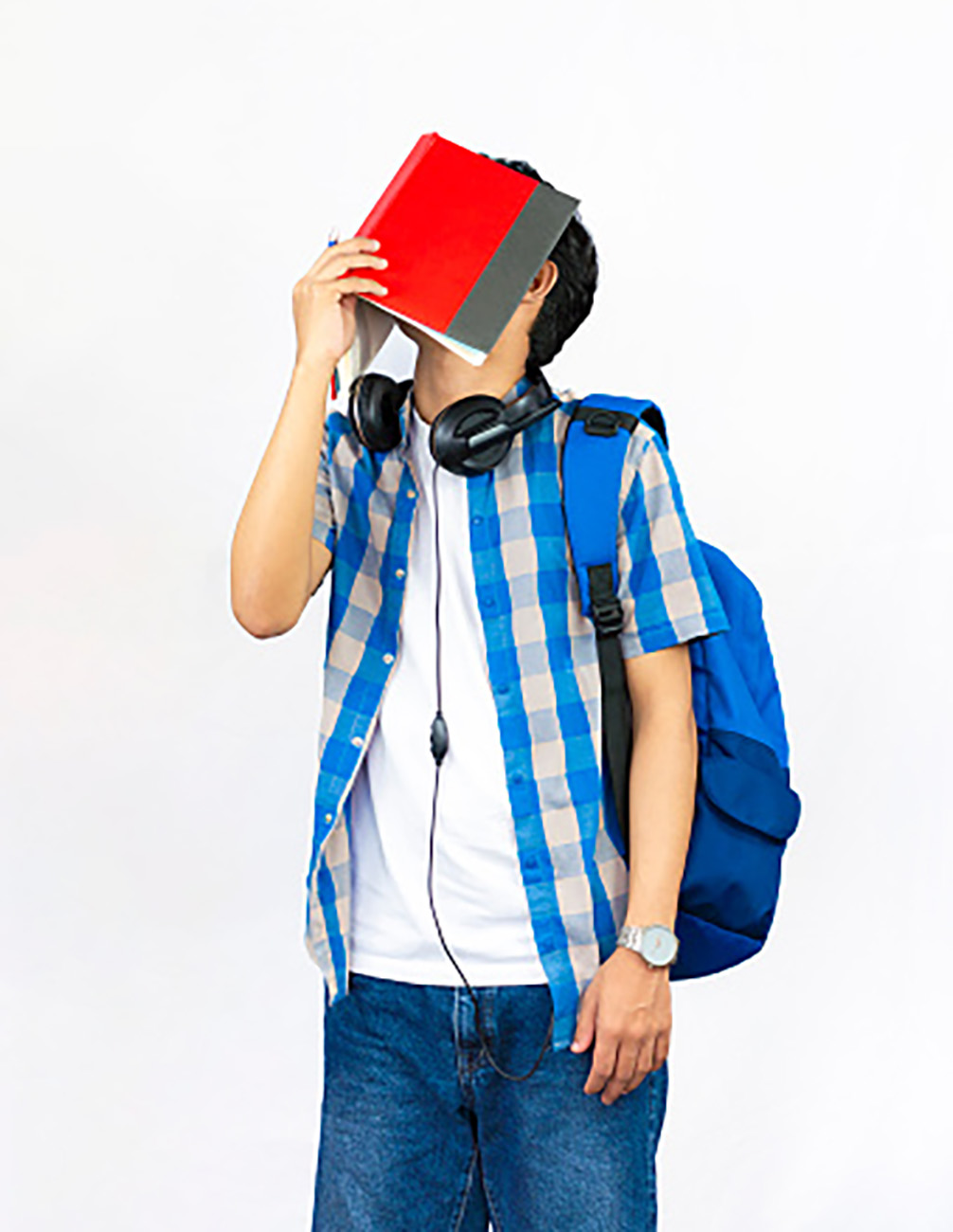 an embarrassed man covers his face with an open book