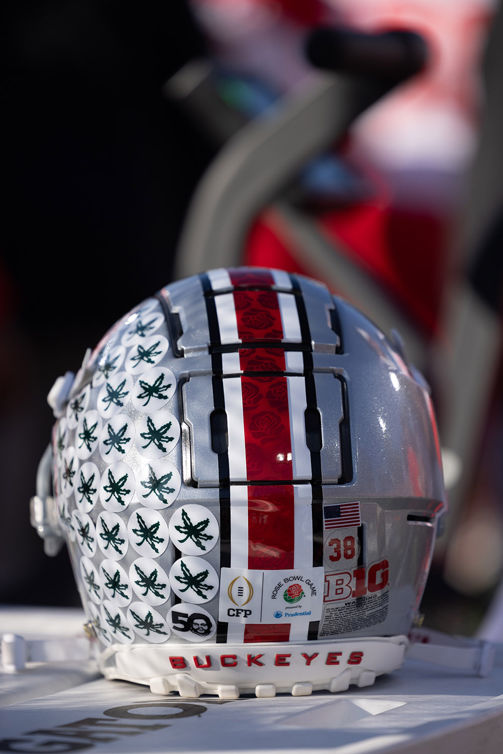 a football helmet shows the round buckeye leaf stickers awarded to players for good plays