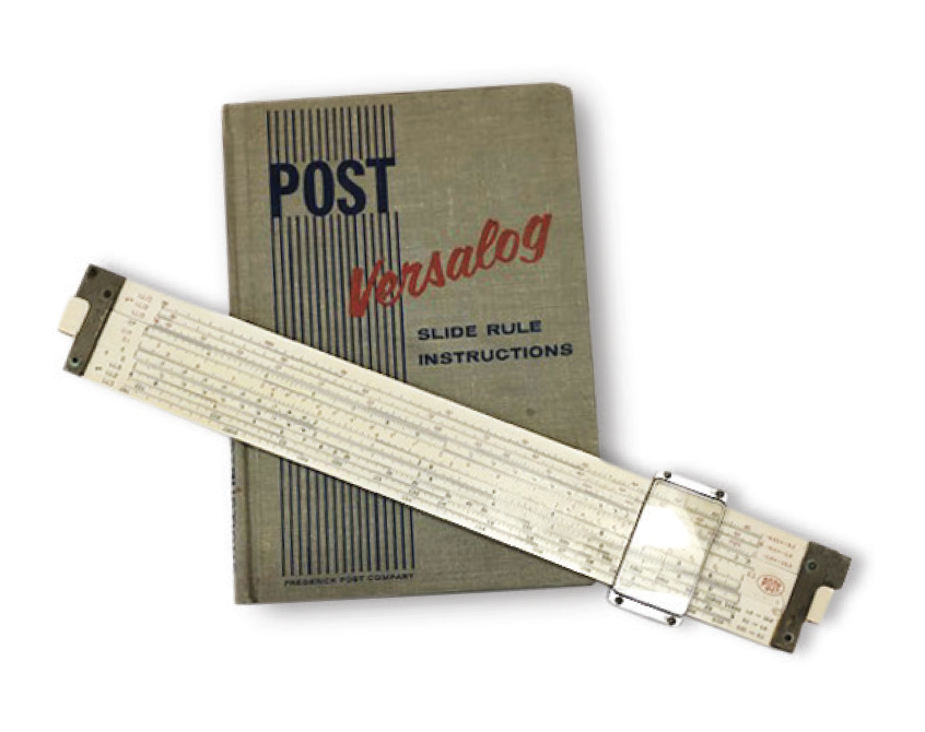 An old slide rule--which looks like an extra-wide ruler with a clear plastic portion that slides along the length--site on top of an instruction manual.
