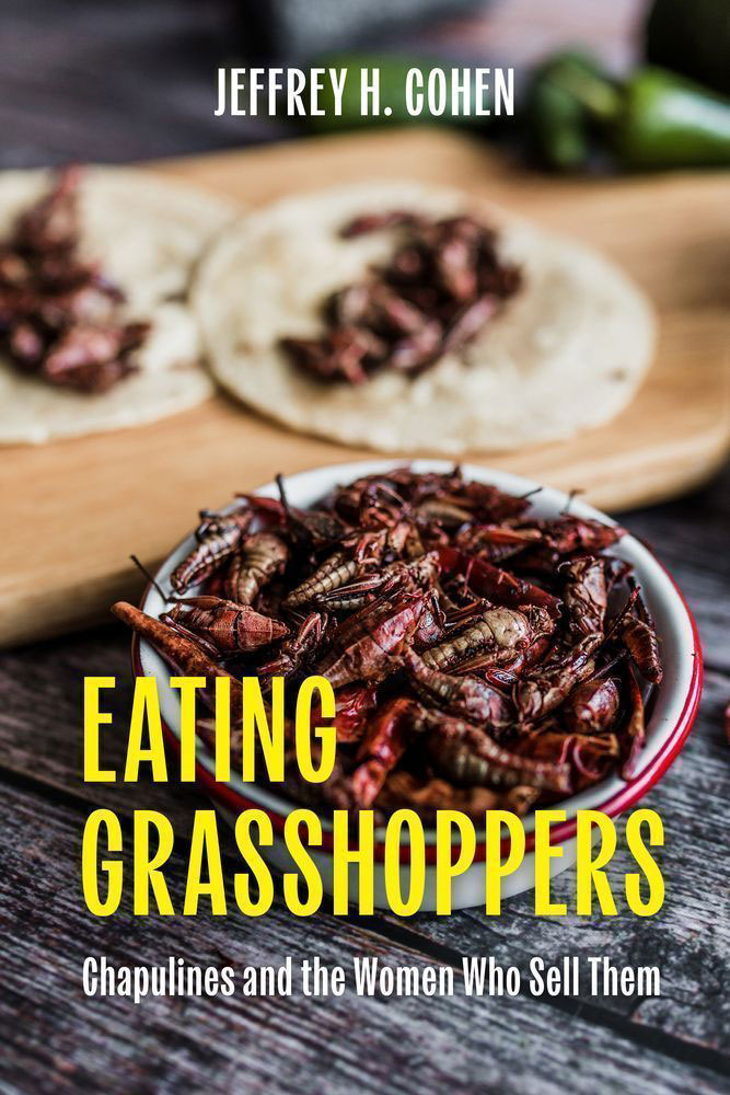 The cover of Jeffrey H. Cohen's book shows chapulines that look like tiny cooked lobsters in small piles on tortillas. The text on the cover says “Eating Grasshoppers: Chapulines and the women who sell them.” 