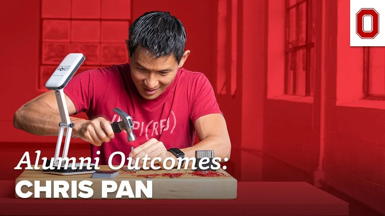 Image of Chris Pan in front of red background hammering