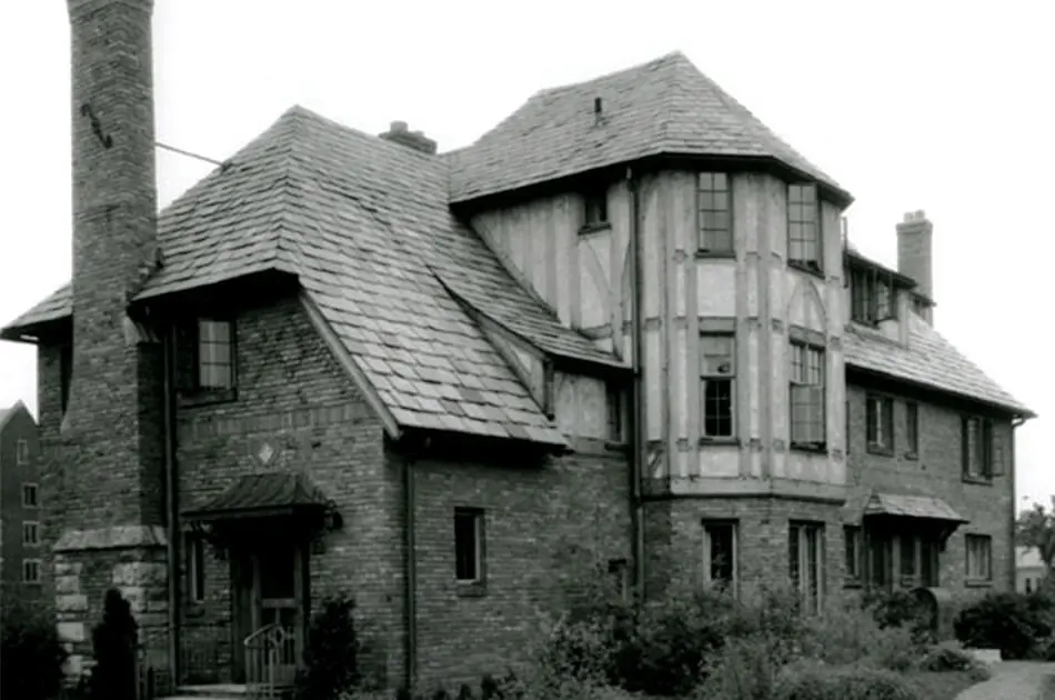 Black and white image of the Home Management House, multi-story, German-style home. 