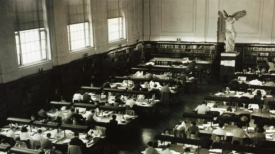 Black and white archival photo of the original Nike of Samothrace in the library