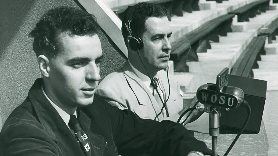 two men doing a radio report of a sporting event