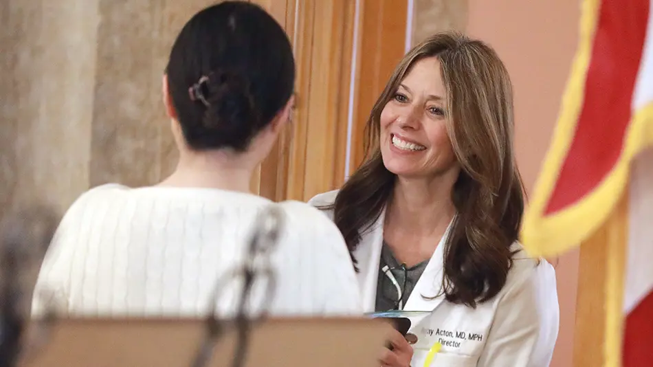 dr amy acton accepts a gift from a woman