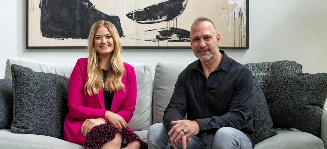 Maddie and Chris Spielman sitting on a couch