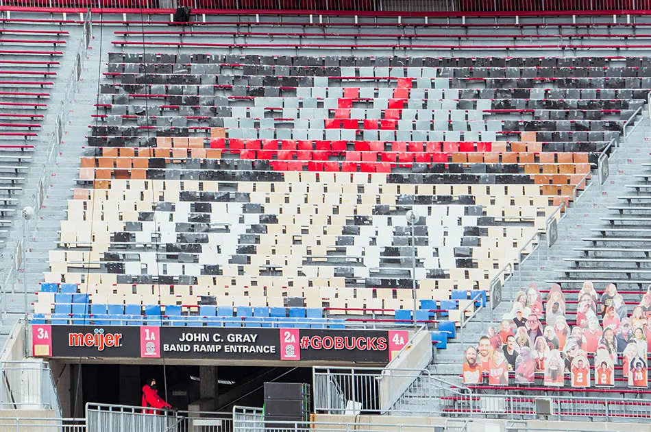 Colored plastic cards are positioned in the stands of Ohio Stadium to resemble the face of Brutus the Buckeye.