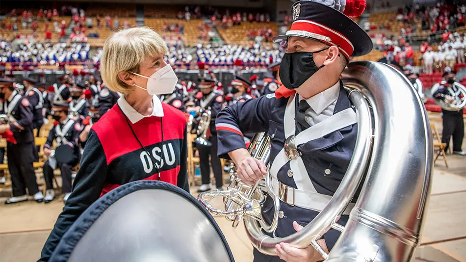 kristina johnson speaking to member of marching band