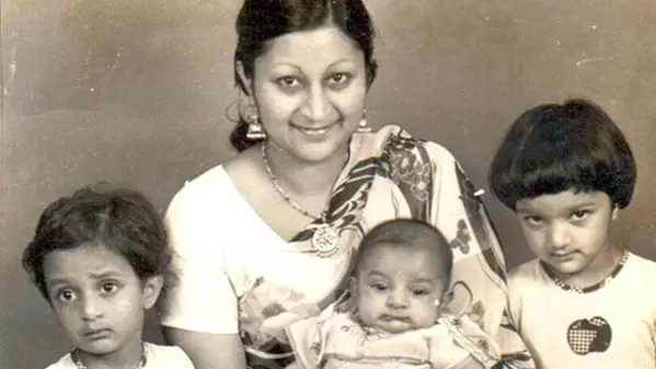 A sepia-toned family photo shows Rattan's wife and three children. The youngest is a baby.
