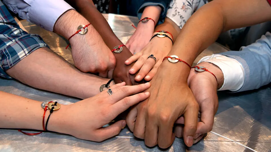 Photo of diverse arms showing off bracelets