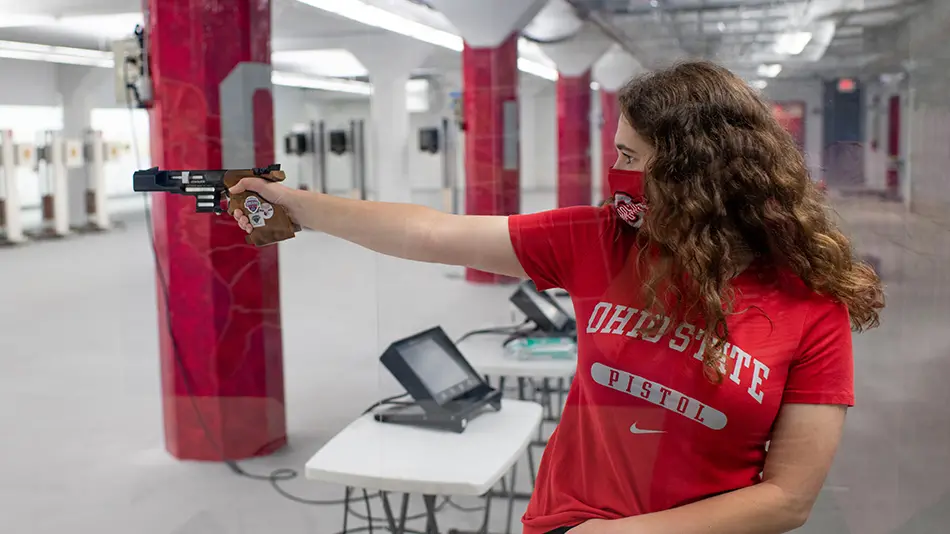 Woman on the OSU Pistol Team practices shooting pistol