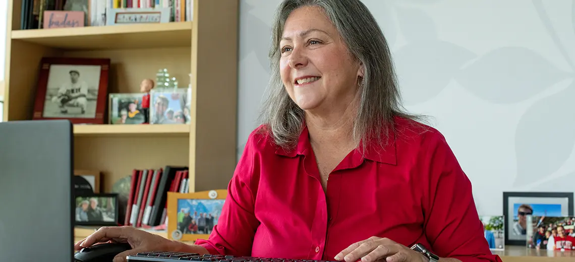 Molly Ranz Calhoun smiling using a computer