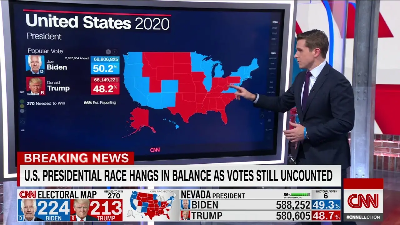 Phil Mattingly is on the CNN news set next to a large digital display during the presidential election as the results are coming in