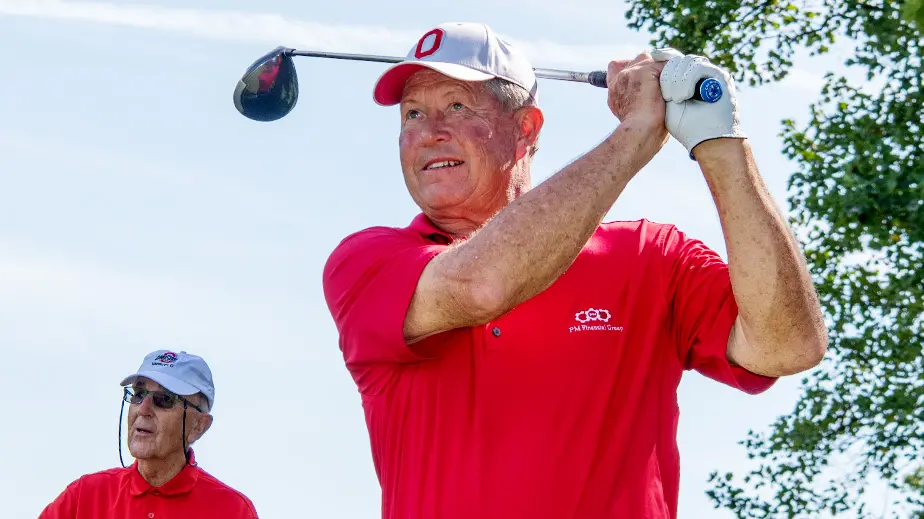 man in red polo playing golf