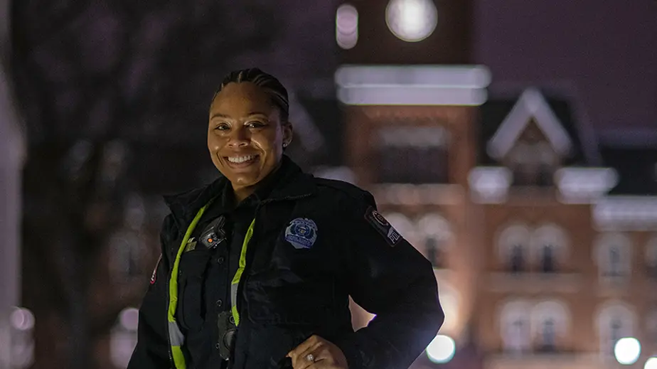 Officer Ari Ross portrait in uniform at night