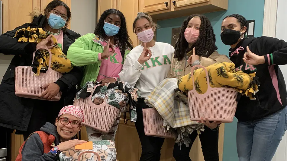 Students from Ohio State’s chapter of Alpha Kappa Alpha holding bags of blankets