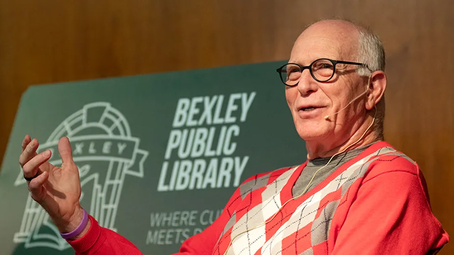Rex Kern in front of sign for bexley public library