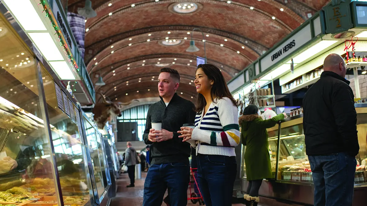 man and woman choosing dinner ingredients inside the West Side Market